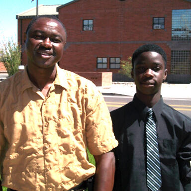 two men in front of building